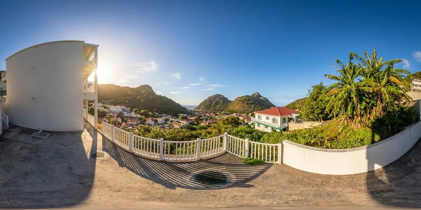 A panoramic view from a Hillside balcony towards the green hills